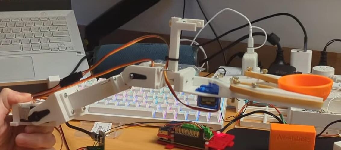 Bench test of the 3DOF robot arm and gripper prototype, wired up to a microcontroller