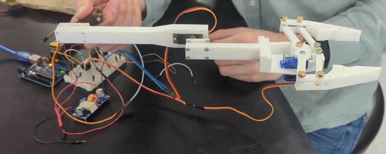 Close-up of the gripper holding a test item during a bench trial